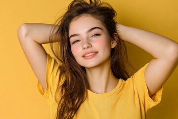 Fototapeta premium Charming young girl smiles brightly in a stylish yellow blouse against a vibrant background