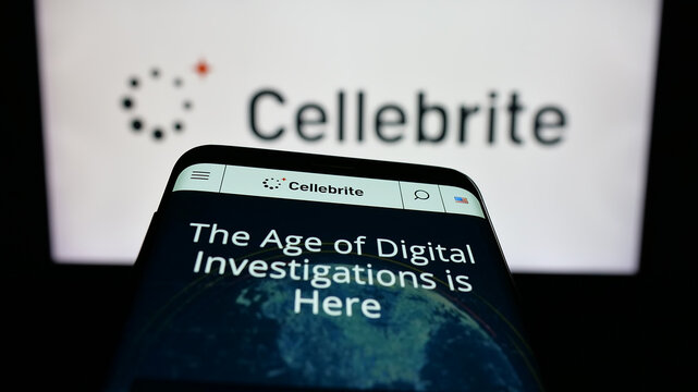 Stuttgart, Germany - 12-17-2025: Mobile phone with website of digital forensics company Cellebrite DI Ltd. on screen in front of logo. Focus on top-left of phone display.