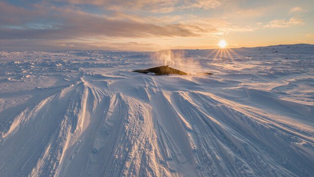 Winter Tundra Landscape with Steaming Fumarole and Sunburst