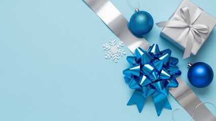 Festive holiday decorations with blue ornaments and silver gift