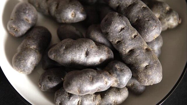 Purple potatoe raw fruit blue potatoes vegetable dish fresh gourmet food background on the table rustic food top view copy space