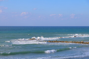 Sea waves crashing on the rocky shore of the Mediterranean Sea in Israel