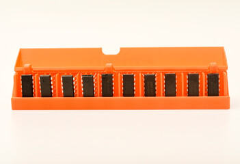 Microchips in a plastic case. Integrated circuits in a plastic storage case. Electronic chips.