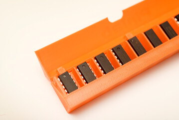 Microchips in a plastic case. Integrated circuits in a plastic storage case. Electronic chips.