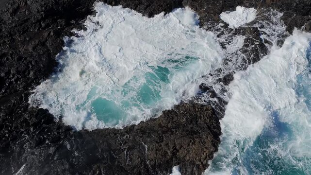 Volcanic Hydro-Explosion: 4K View of the Atlantic Ocean Surging Through the Basaltic Blowholes of El Bufadero de la Garita, Gran Canaria, Canary Islands, Spain