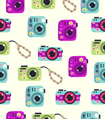 Pattern of cameras with stickers on a light beige background.