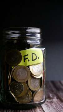 Kolkata, India, dated 28.12.2025. Glass Jar with Indian Rupee Coins Representing Savings, FD and SIP Investments