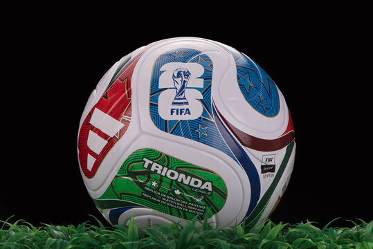 FIFA Trionda League Soccer Ball on Grass Isolated on Black Background