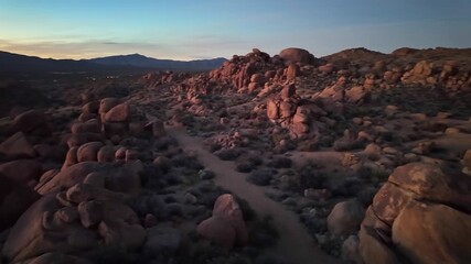Vibrant sunset view of rock formations along Mastodon Peak Trail in Joshua Tree National Park California