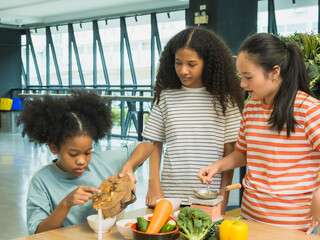 Group three children prepare healthy meal together in bright, modern kitchen. Surrounded fresh vegetable like bell pepper broccoli carrot engage in fun and education cook activity. creating vibrant