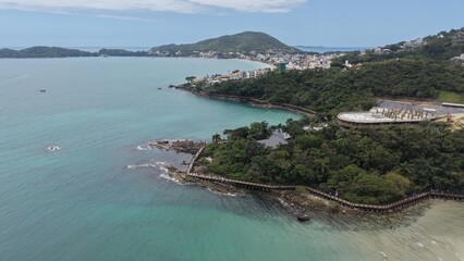 Fototapeta premium Aerial view of Praia de Bombinhas in Santa Catarina, Brazil, with turquoise water and lush greenery