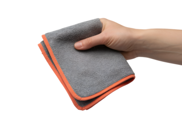 Hand holding a grey folded cloth with orange edging . Isolated on transparent background, png