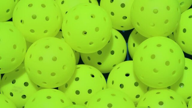 Pickleball balls close view and the balls beeing dropped in