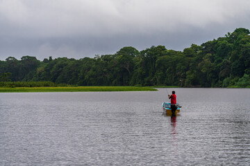 Local man fishing in the canals in the Tortuguero National Park in Costa Rica after a rain storm