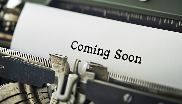 Vintage typewriter with paper sheet typed Coming Soon in black font. Old mechanical writing machine closeup. Retro office equipment