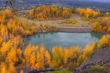 Autumn landscape in a quarry surrounded by colorful trees, Kozy, Poland, Silesian Voivodeship, natural background or wallpaper