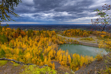 Autumn landscape in a quarry surrounded by colorful trees, Kozy, Poland, Silesian Voivodeship, natural background or wallpaper