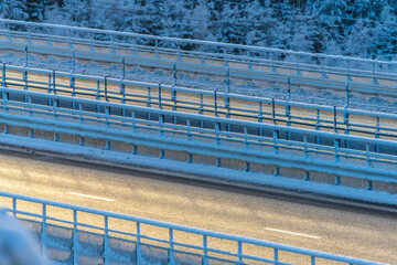 Icy winter road bridge with frost and snow.