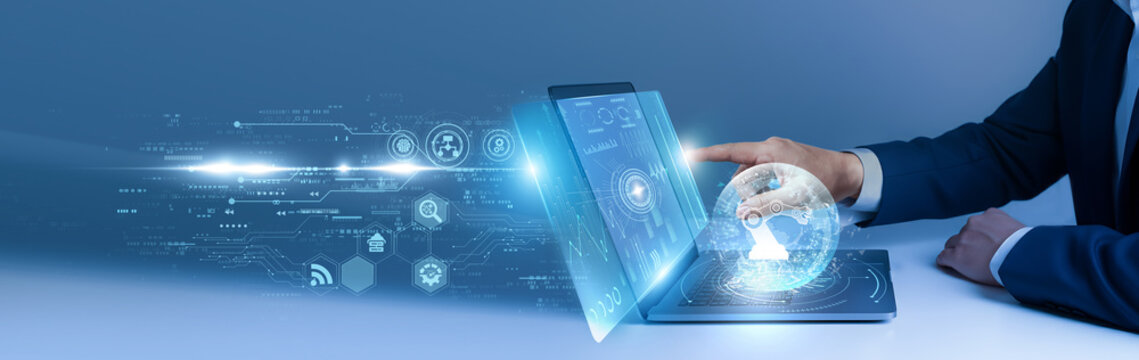 Businessman using laptop and analyze the robotics system on digital interface. automation technology, industrial robots, AI machines, smart manufacturing, engineering innovation