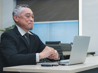 business man in suit analyzing charts and graphs on laptop screen in office setting. image show data visualization such as pie chart and bar graph, representing business analytics and decision-making.