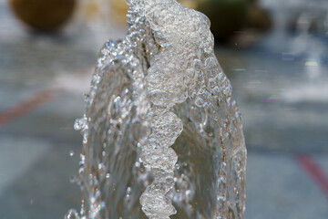 Water fountain creating bubbles in a public space during daytime