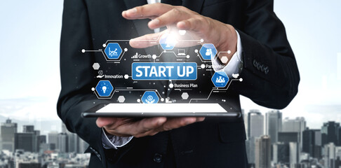 A business professional holds a tablet displaying a startup concept with futuristic graphics, highlighting themes of innovation and growth against a city skyline. Tessel