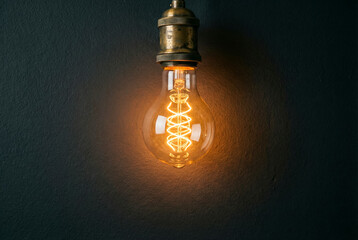 Bright filament inside glass lamp symbolizing creative inspiration