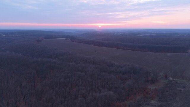 Drone tracking shot over winter sunset