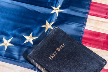 Holy Bible on tea stained Betsy Ross American flag