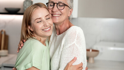 Elderly mother and adult daughter share joy and warmth at home during weekend