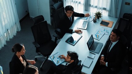 Top view of smart executive manager financial graph to diverse team while group of multicultural business people planning marketing strategy by using stock investment chart at meeting. Directorate. - Powered by Adobe