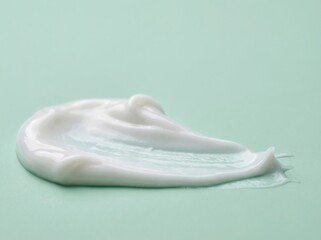 Smooth white cream on mint surface