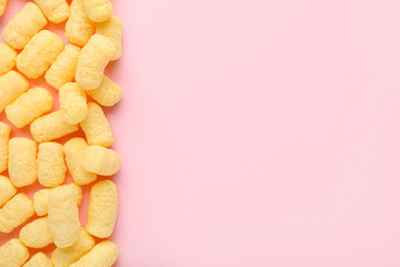 Sweet corn sticks on pink background
