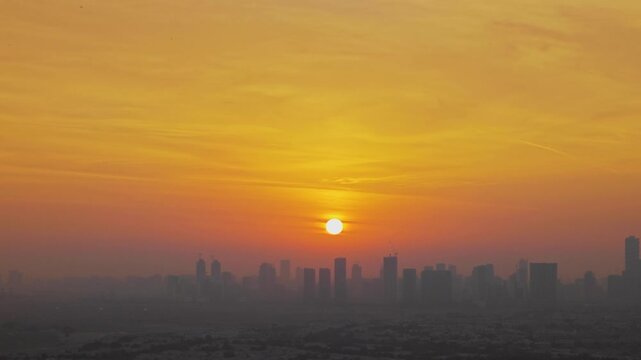 Sunrise over Dubai skyline, skyscrapers in morning glow, urban landscape, modern architecture. Aerial 4K drone video footage of golden hour and Dubai sunset