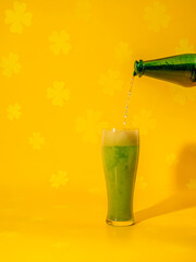 a green drink being poured into a glass