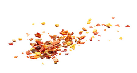 Close up spicy chili red pepper flakes, chopped, milled dry paprika pile isolated on white...