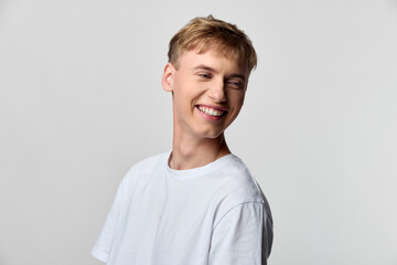 Smiling man in casual clothing wearing a white t shirt, youthful expression and friendly vibe in a studio shot, conveying upbeat lifestyle, approachable style and positive energy for creative stock