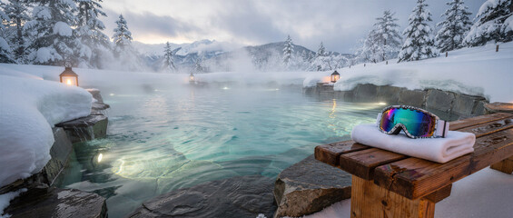 Steaming geothermal pool with ski goggles and towel on wooden bench, surrounded by pristine snow and mountain peaks. Perfect for luxury travel, winter wellness, and spa resort marketing