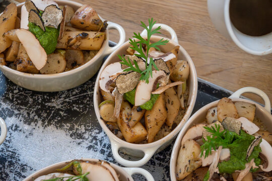 High cuisine cooking experince with chef in cook studio in Paris, oven baked vegetarian dish with vegetables, truffle mushrooms, cheese, black salsify, mousse and nuts
