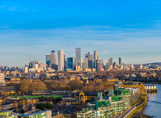 Canary Wharf skyline in the distance - modern London financial district panorama with skyscrapers. Aerial drone view angle from Tower Bridge side