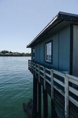 Wooden Pier Building Over Calm Coastal Water