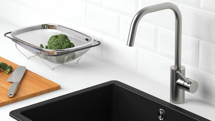 Fresh vegetables being washed in a modern kitchen with a sink and cutting board.
