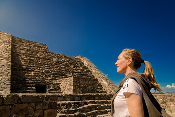 Tourist woman admiring ancient Ehecatl Quetzalcoatl temple in Calixtlahuaca, Mexico