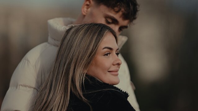A young couple embraces affectionately in Paris France The image captures a romantic moment between the woman and man suitable for travel lifestyle or relationship themes.