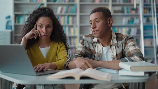 Tired ethnic students African American man Latino Arabian woman library laptop project burnout team exhausted sleepy classmates university learn study preparing difficult exam textbook book education