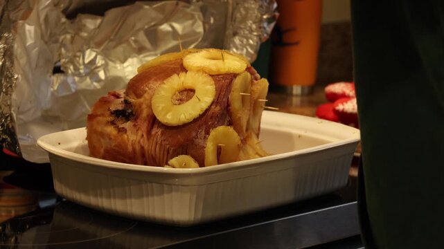 uncovering maple glazed ham and checking cook temp