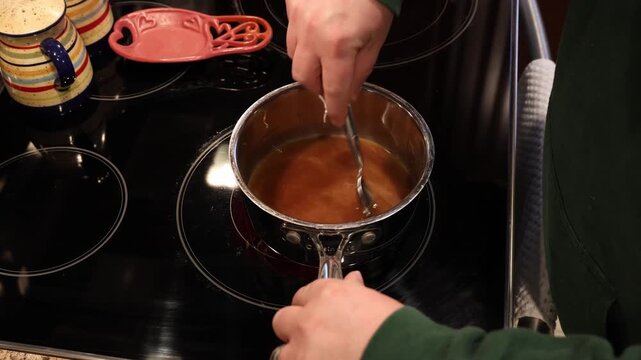 strutting a marinade glaze on electric stove top to glaze a ham