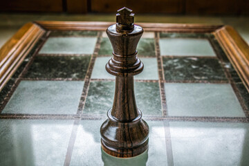 a chess piece on a glass table