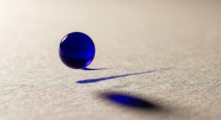Floating ultramarine orb casting a sharp shadow on textured surface