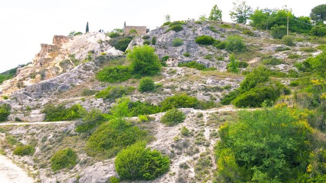Bagno Vignoni natural pools along the city hill in Tuscany, view in spring season from drone
